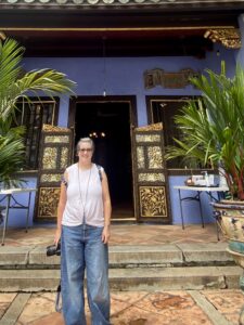 Kamsin standing outside NUS Baba House in Singapore
